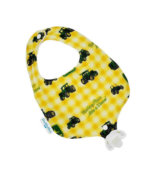 Absorbent drool bib with pacifier or teether attachment